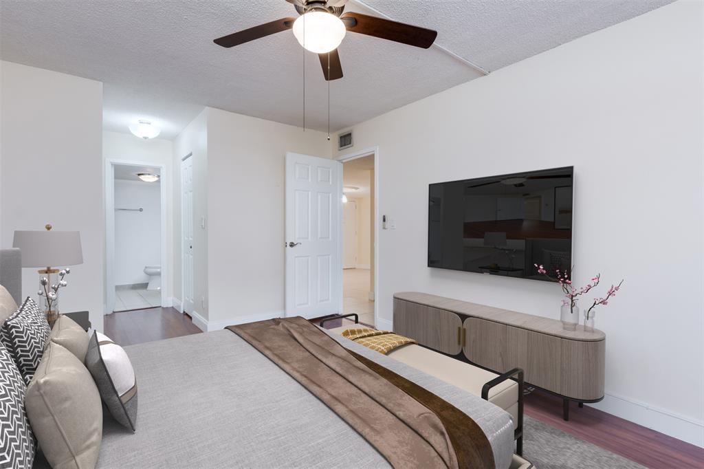 3000 Northeast 5th Terrace, Unit 110A Wilton Manors, FL 33334 - Photo 17 of 30 a bedroom with a bed and a flat screen tv