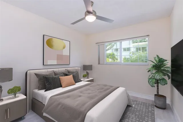 a bedroom with a bed and a potted plant