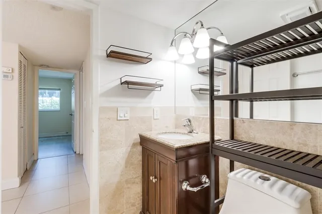 a kitchen with a refrigerator and a sink