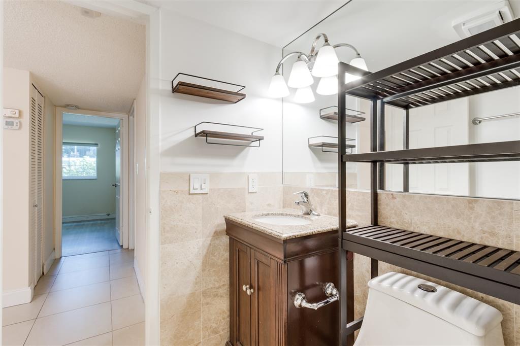 3000 Northeast 5th Terrace, Unit 110A Wilton Manors, FL 33334 - Photo 24 of 30 a kitchen with a refrigerator and a sink