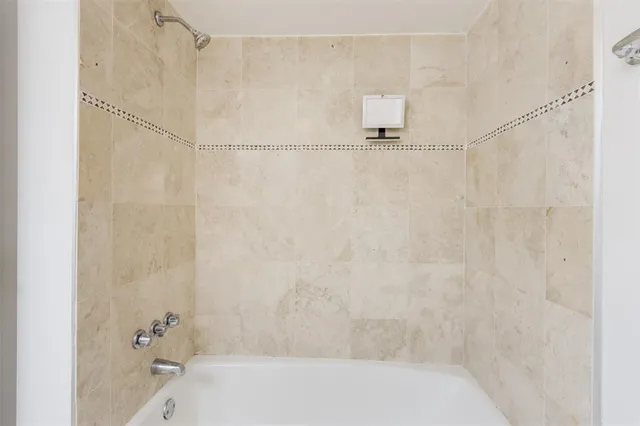 a bathroom with a bathtub and shower