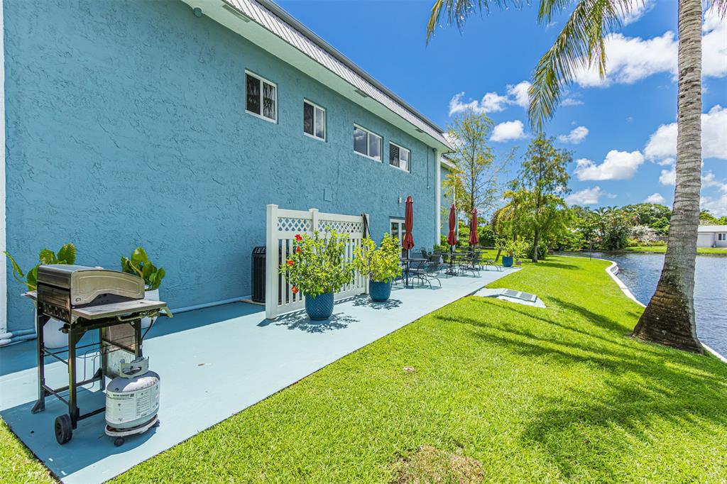 3000 Northeast 5th Terrace, Unit 110A Wilton Manors, FL 33334 - Photo 30 of 30 a view of a backyard with plants and a patio