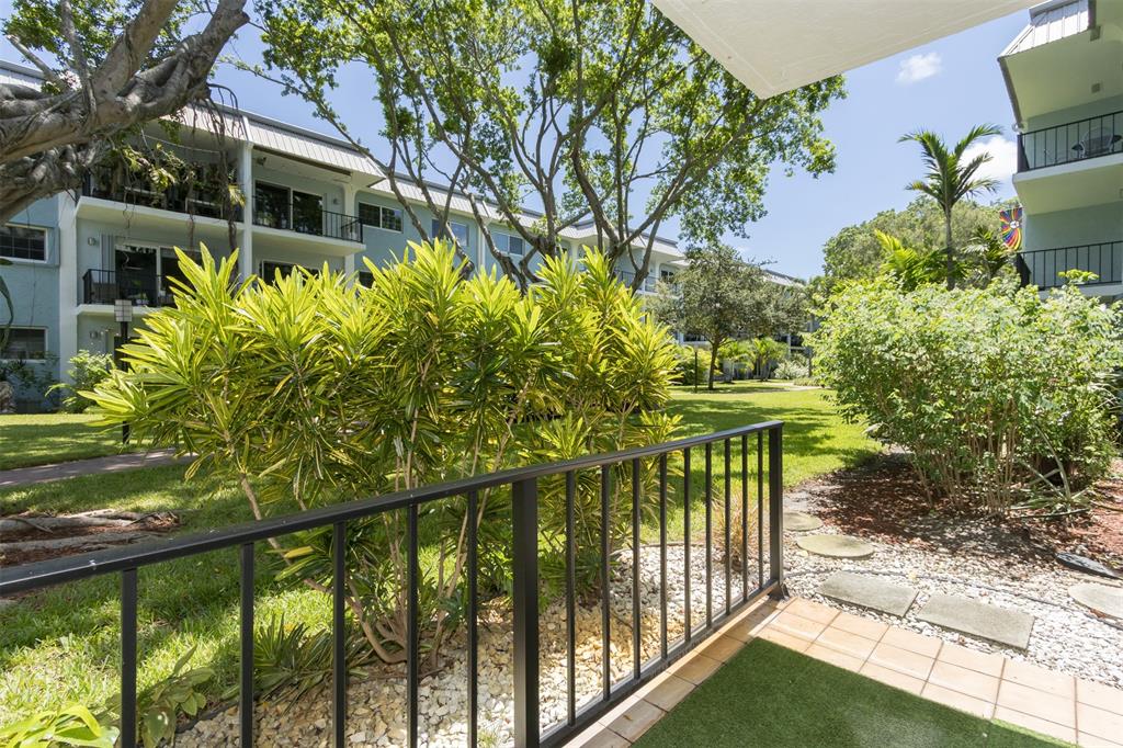 3000 Northeast 5th Terrace, Unit 110A Wilton Manors, FL 33334 - Photo 6 of 30 a view of a house with large windows and a small yard