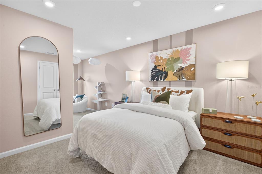 8846 Ginko Run Parrish, FL 34219 - Photo 15 of 24 a bed room with a bed and a mirror