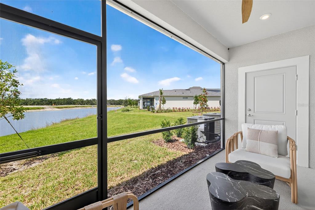 8846 Ginko Run Parrish, FL 34219 - Photo 20 of 24 a view of a living room and a floor to ceiling window or kitchen
