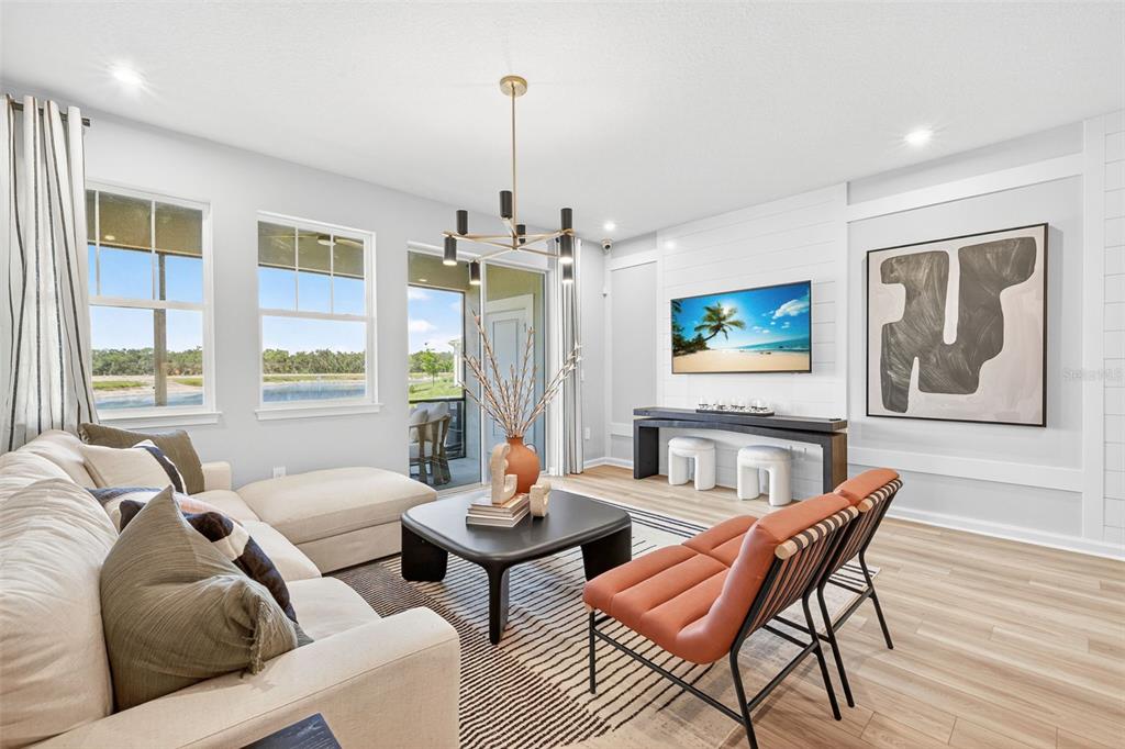 8846 Ginko Run Parrish, FL 34219 - Photo 8 of 24 a living room with furniture and a chandelier