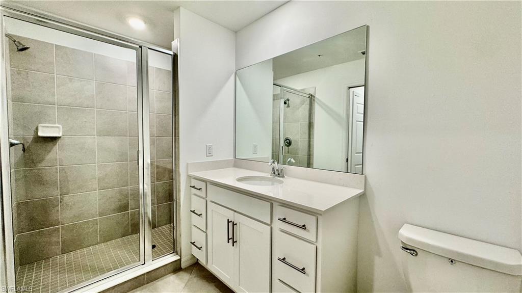 43993 Boardwalk Loop, Unit 1932 Punta Gorda, FL 33982 - Photo 11 of 17 a bathroom with a shower sink and mirror