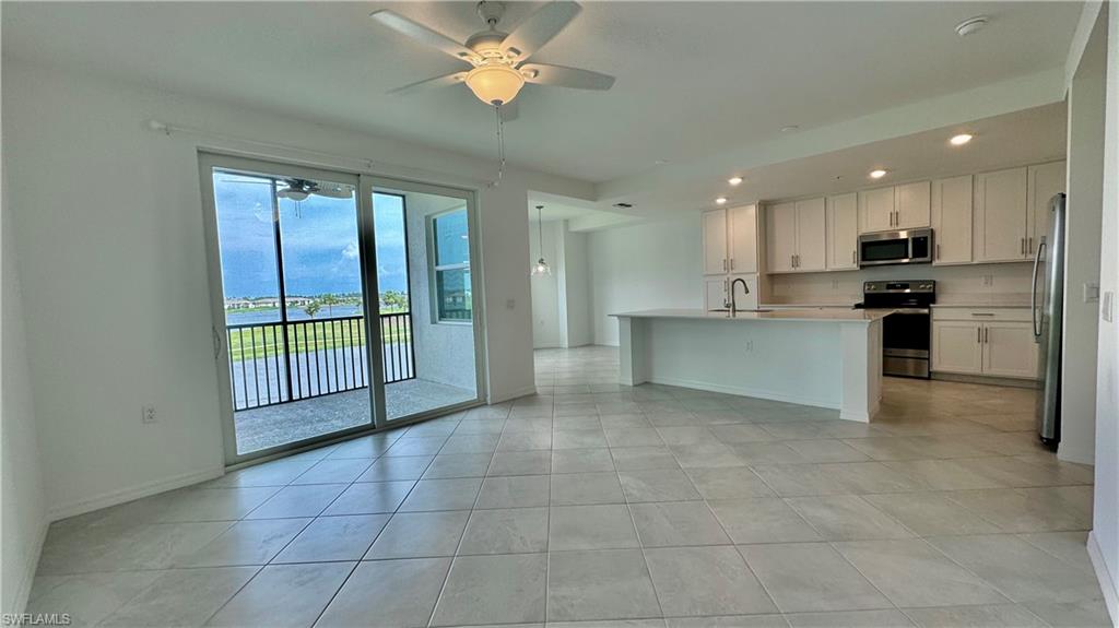 43993 Boardwalk Loop, Unit 1932 Punta Gorda, FL 33982 - Photo 2 of 17 a open kitchen with stainless steel appliances granite countertop a stove and a refrigerator