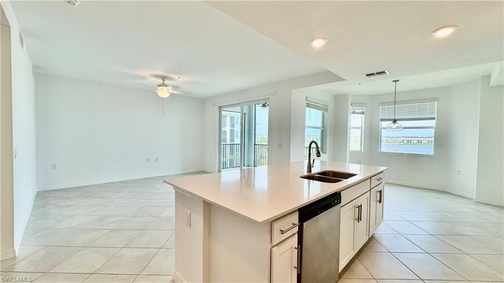 43993 Boardwalk Loop, Unit 1932 Punta Gorda, FL 33982 - Photo 3 of 17 a kitchen with granite countertop a sink cabinets and window