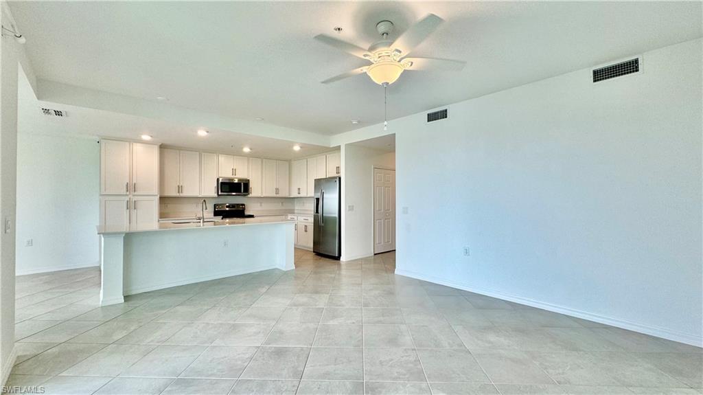 43993 Boardwalk Loop, Unit 1932 Punta Gorda, FL 33982 - Photo 6 of 17 a large kitchen with a refrigerator a stove top oven a sink and dishwasher