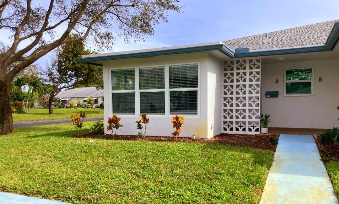 1155 South Drive Circle, Unit A Delray Beach, FL 33445 - Photo 1 of 21 a house view with a garden space