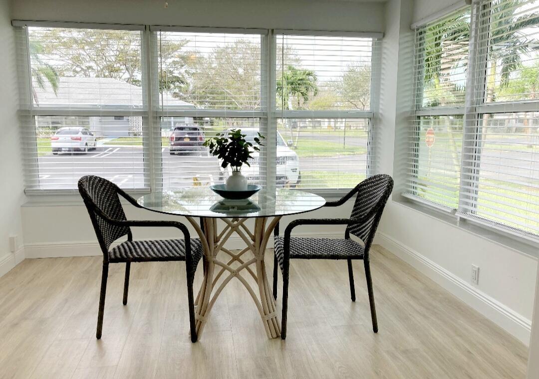 1155 South Drive Circle, Unit A Delray Beach, FL 33445 - Photo 11 of 21 a dining room with furniture and window
