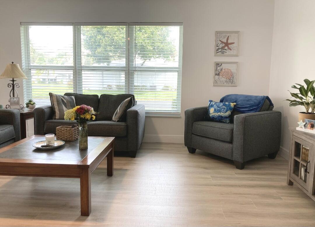 1155 South Drive Circle, Unit A Delray Beach, FL 33445 - Photo 12 of 21 a living room with furniture and a floor to ceiling window