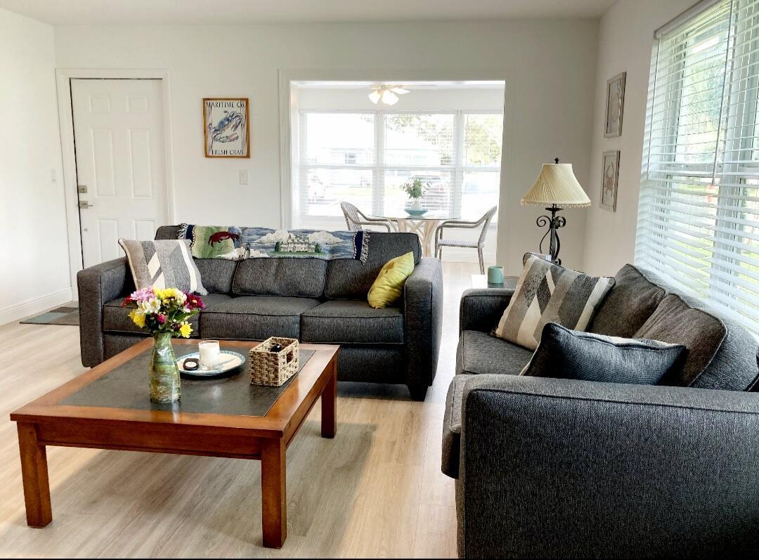 1155 South Drive Circle, Unit A Delray Beach, FL 33445 - Photo 14 of 21 a living room with furniture and a large window