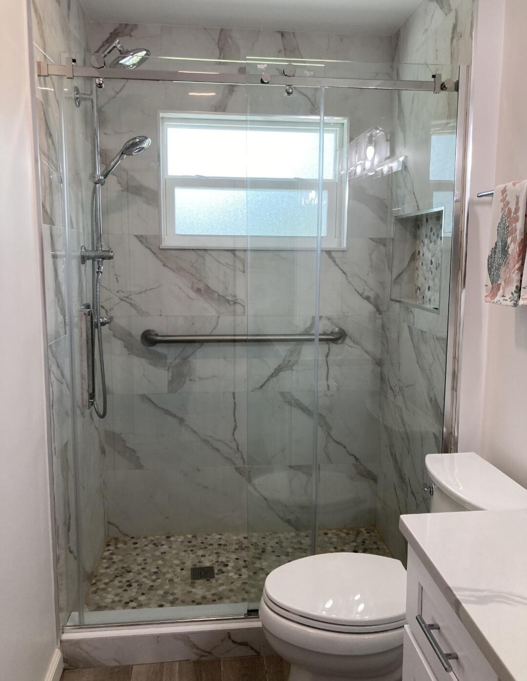 1155 South Drive Circle, Unit A Delray Beach, FL 33445 - Photo 16 of 21 a bathroom with a toilet and a shower