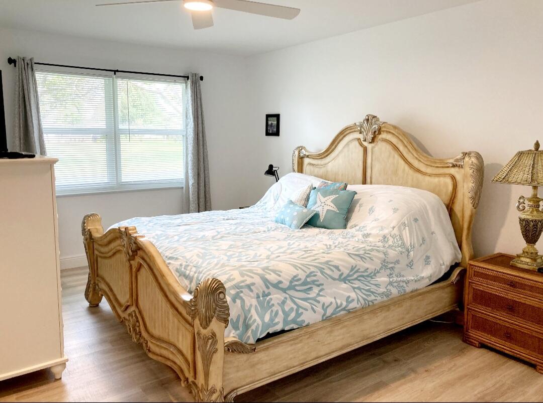 1155 South Drive Circle, Unit A Delray Beach, FL 33445 - Photo 19 of 21 a bedroom with a bed and window