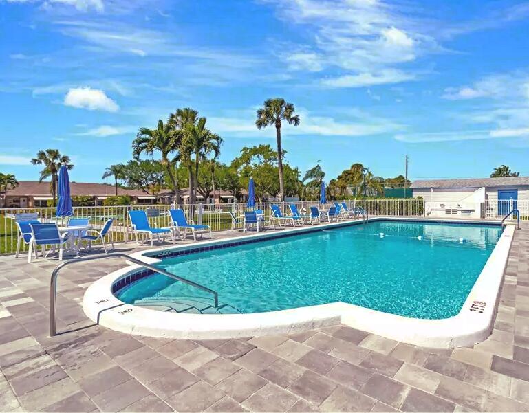 1155 South Drive Circle, Unit A Delray Beach, FL 33445 - Photo 21 of 21 a view of a swimming pool with outdoor seating