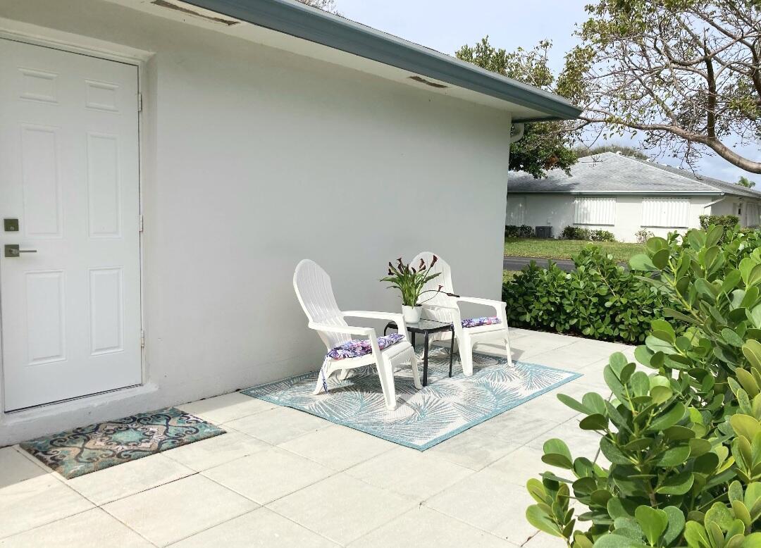 1155 South Drive Circle, Unit A Delray Beach, FL 33445 - Photo 5 of 21 a view of a patio with table and chairs and potted plants