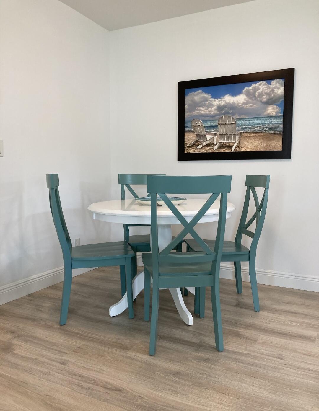 1155 South Drive Circle, Unit A Delray Beach, FL 33445 - Photo 8 of 21 a view of a dining room with furniture wooden floor and painting on the wall
