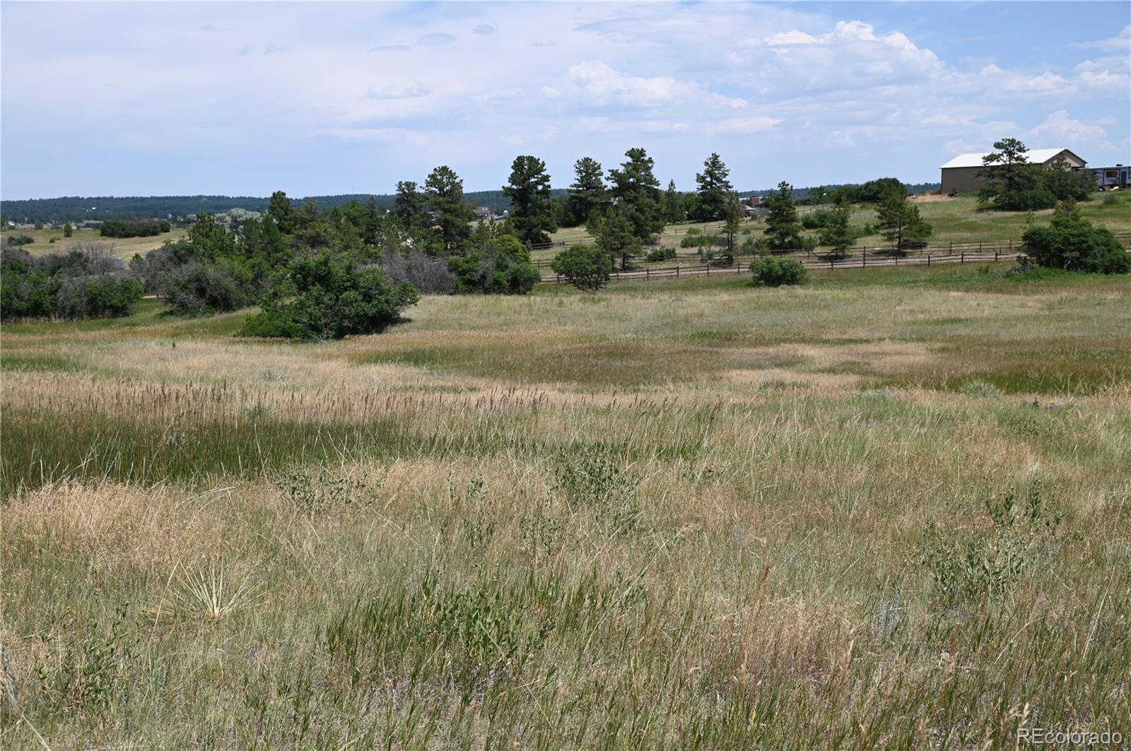 1579 Deerpath Road Franktown, CO 80116 - Photo 22 of 49 a view of a lake with a city