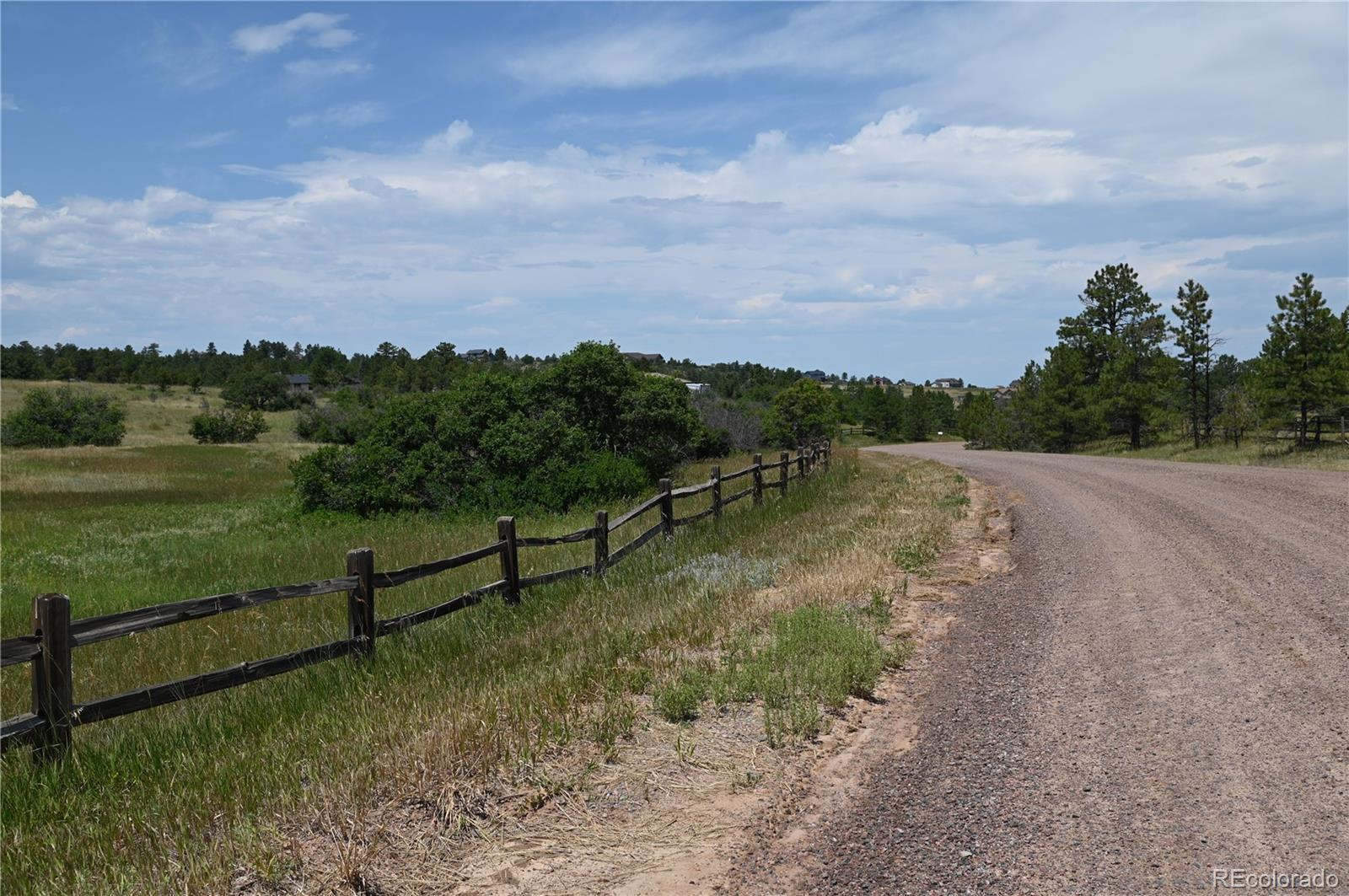 1579 Deerpath Road Franktown, CO 80116 - Photo 5 of 49 a view of a lake with a yard