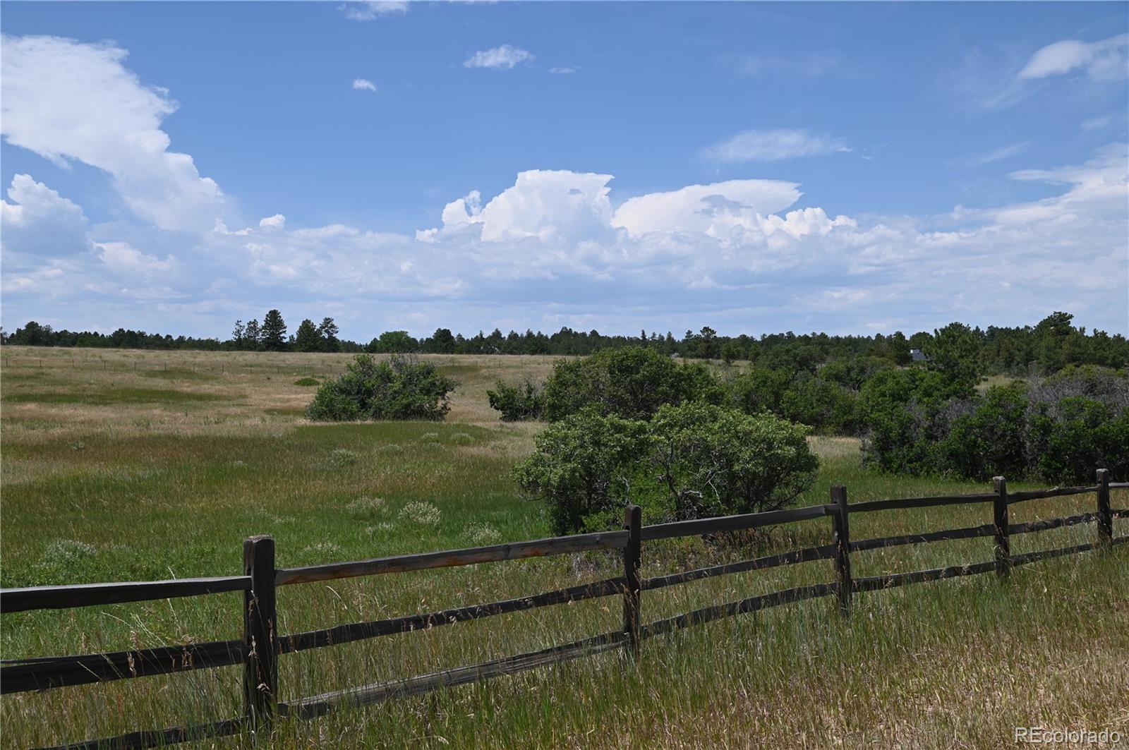 1579 Deerpath Road Franktown, CO 80116 - Photo 9 of 49 a view of a lake from a balcony