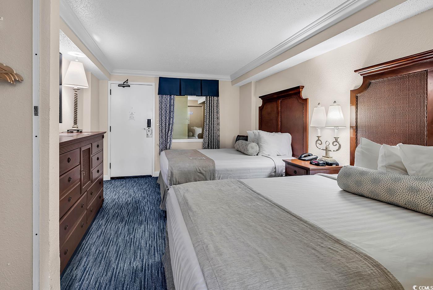 1202 North Ocean Boulevard, Unit 310 Myrtle Beach, SC 29577 - Photo 12 of 29 Bedroom featuring dark wood-style flooring