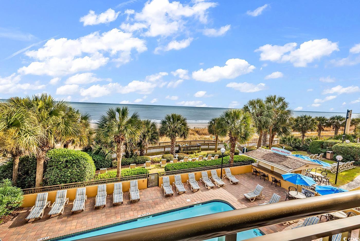 1202 North Ocean Boulevard, Unit 310 Myrtle Beach, SC 29577 - Photo 5 of 29 Community pool featuring a patio area and a water view