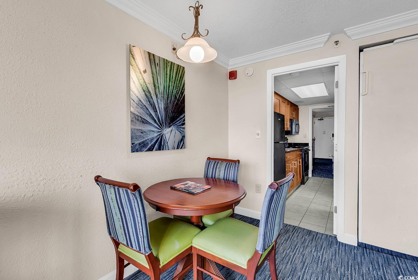 1202 North Ocean Boulevard, Unit 310 Myrtle Beach, SC 29577 - Photo 7 of 29 Dining space with a textured ceiling and crown molding