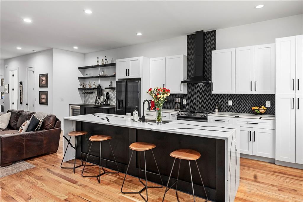 210 Locust Street Northeast Atlanta, GA 30317 - Photo 12 of 54 a kitchen with stainless steel appliances kitchen island granite countertop a sink and cabinets