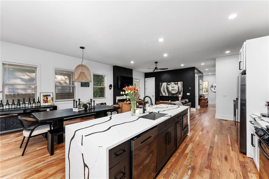 210 Locust Street Northeast Atlanta, GA 30317 - Photo 14 of 54 a kitchen with stainless steel appliances a sink stove and wooden floor