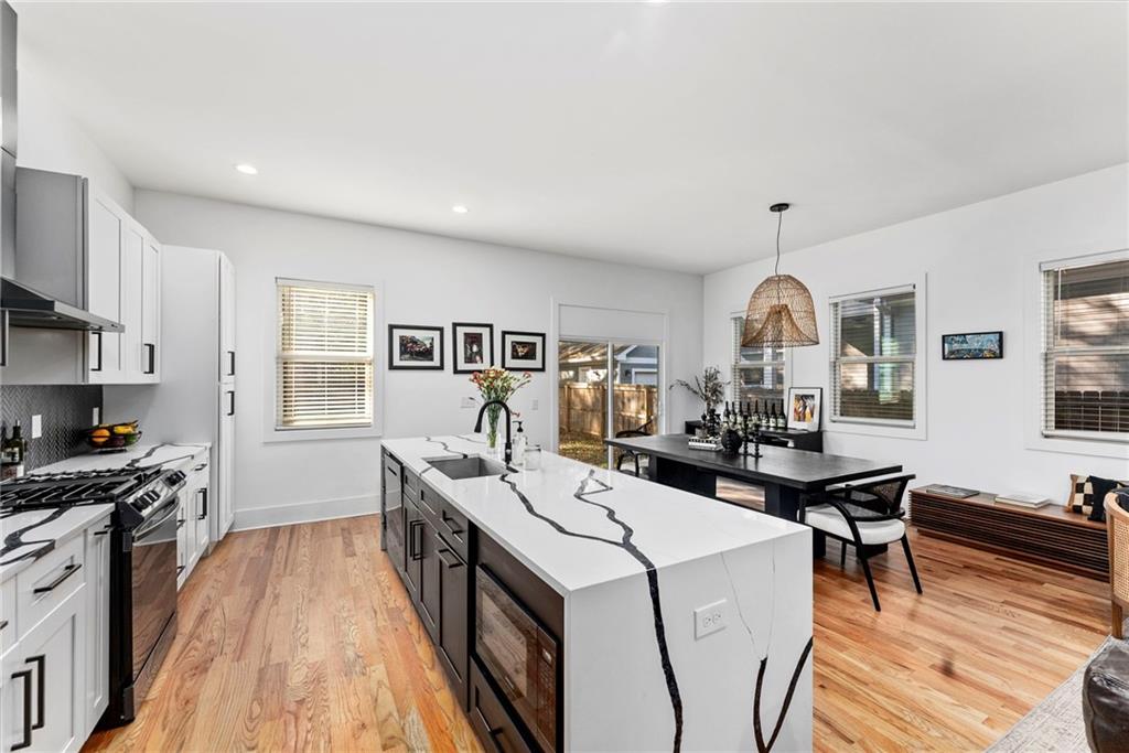 210 Locust Street Northeast Atlanta, GA 30317 - Photo 16 of 54 a view of a kitchen with a sink a microwave and cabinets