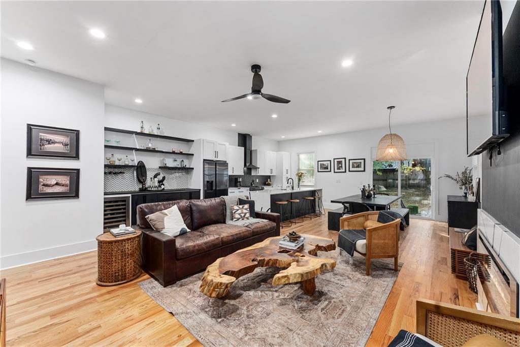 210 Locust Street Northeast Atlanta, GA 30317 - Photo 21 of 54 a living room with furniture a flat screen tv and kitchen view