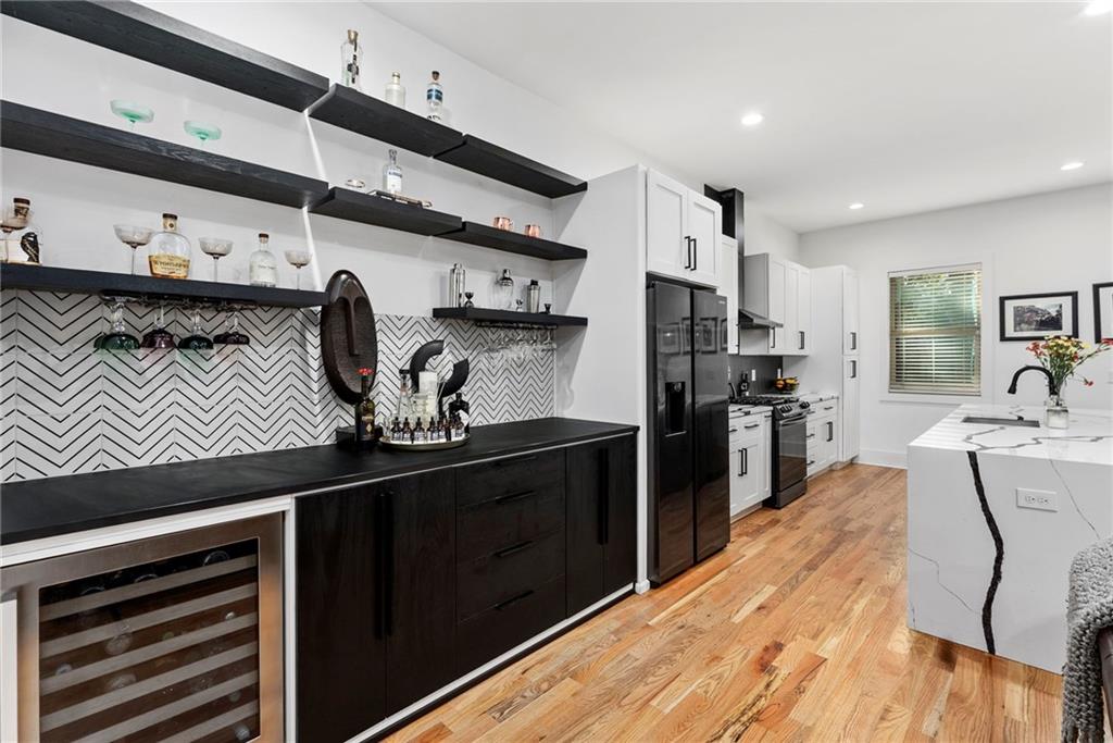 210 Locust Street Northeast Atlanta, GA 30317 - Photo 22 of 54 a kitchen with stainless steel appliances granite countertop a sink stove and refrigerator