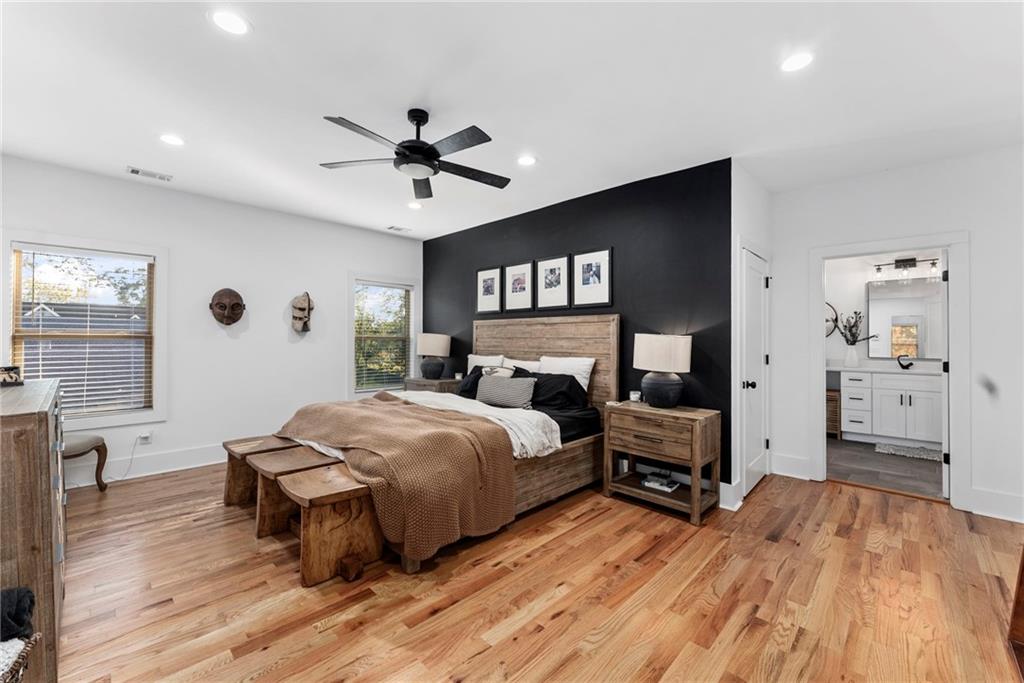 210 Locust Street Northeast Atlanta, GA 30317 - Photo 26 of 54 a spacious bedroom with a bed and a flat screen tv
