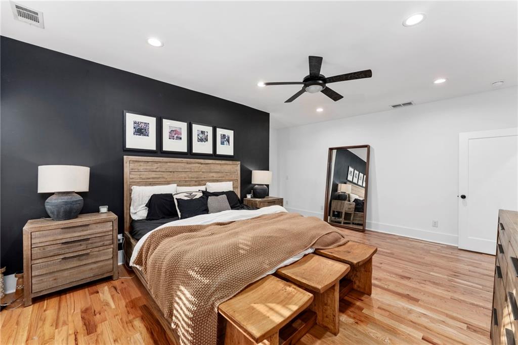 210 Locust Street Northeast Atlanta, GA 30317 - Photo 28 of 54 a bedroom with a bed and a chandelier