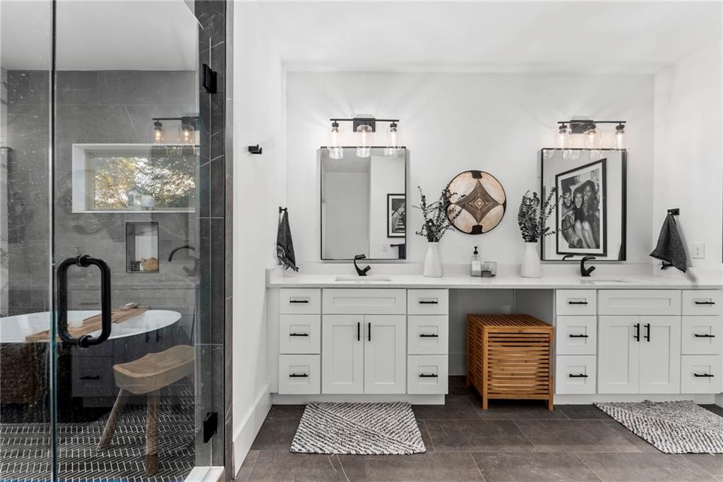 210 Locust Street Northeast Atlanta, GA 30317 - Photo 30 of 54 a spacious bathroom with a double vanity sink and a mirror