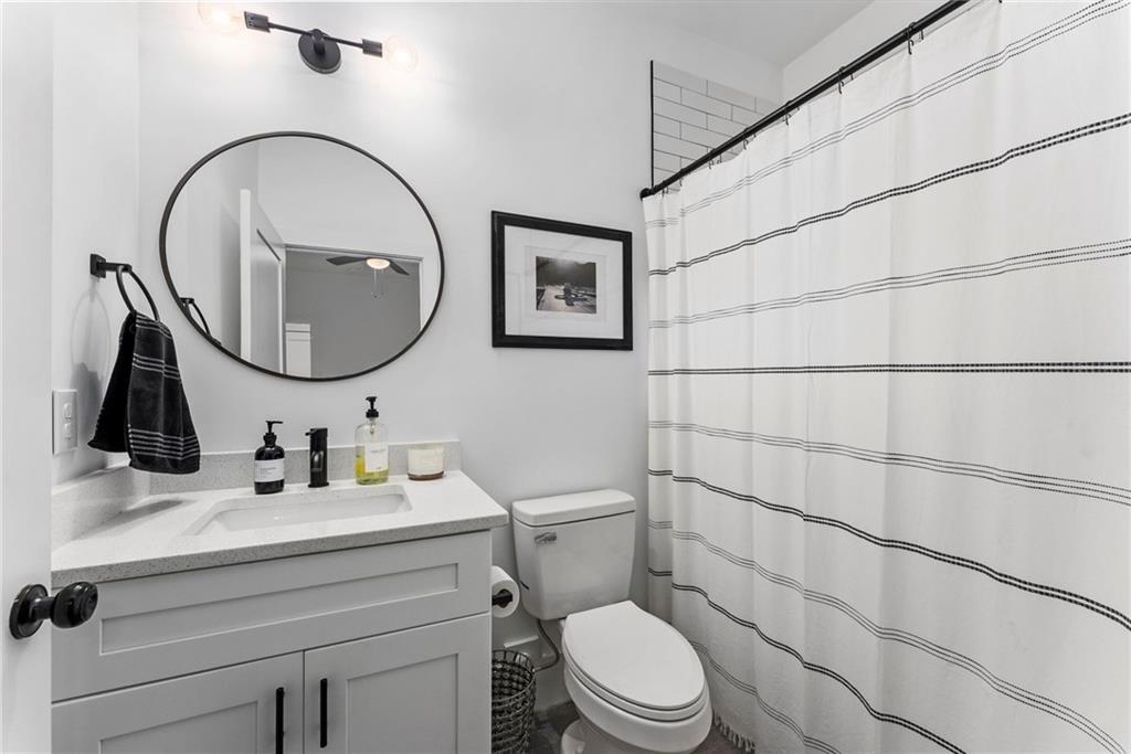 210 Locust Street Northeast Atlanta, GA 30317 - Photo 37 of 54 a bathroom with a sink mirror and toilet