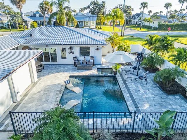 a view of a house with swimming pool patio and outdoor seating