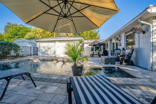 a view of balcony with furniture and umbrella