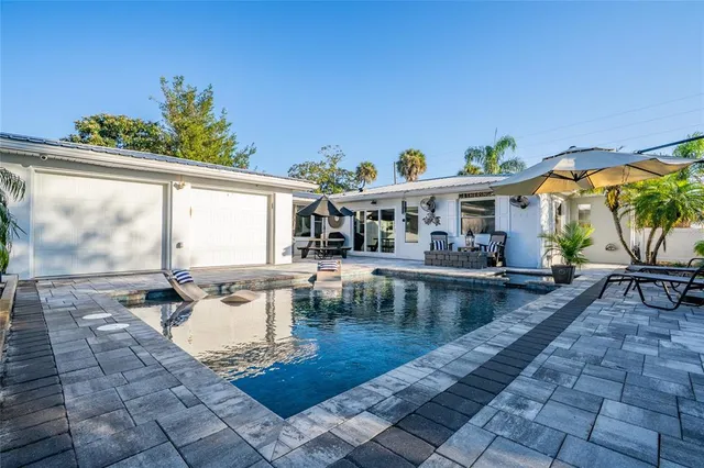swimming pool view with a seating space