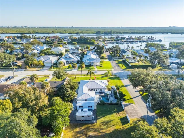 an aerial view of residential houses with outdoor space and swimming pool