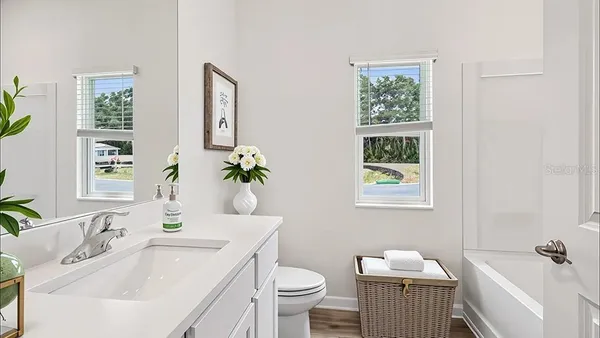 a bathroom with a sink toilet and a mirror