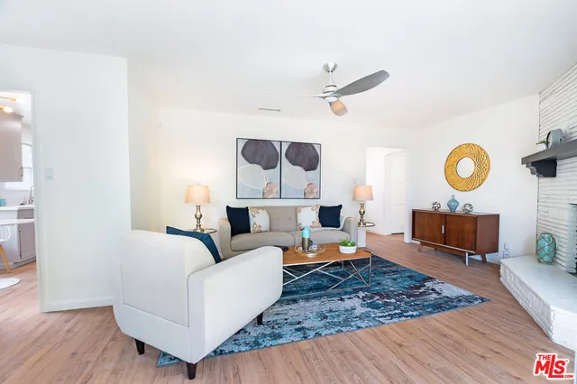 a kitchen with a table chairs stove and wooden floor