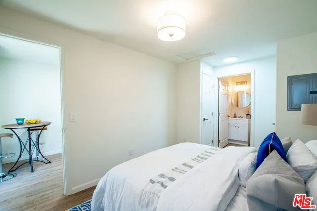 a bathroom with a toilet sink vanity tub and mirror
