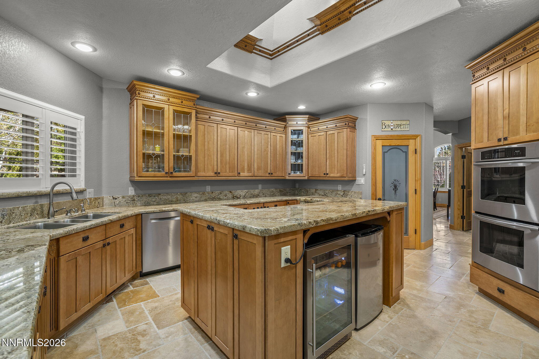14501 Quail Rock Court Reno, NV 89511 - Photo 14 of 42 a kitchen with granite countertop stainless steel appliances and wooden cabinets