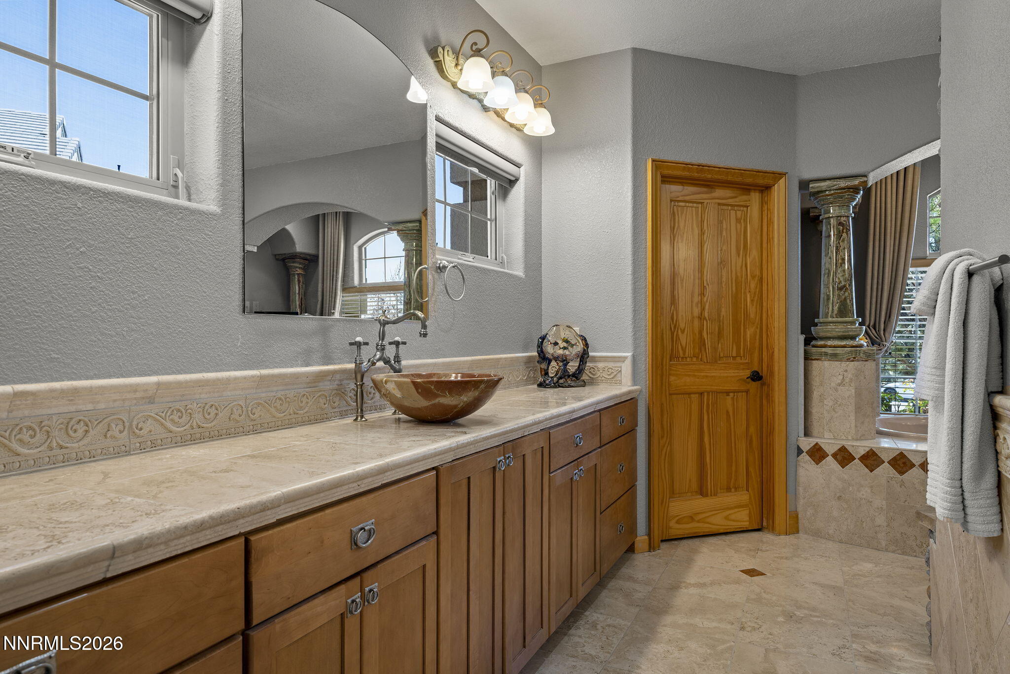 14501 Quail Rock Court Reno, NV 89511 - Photo 24 of 42 a bathroom with a sink a mirror and a shower