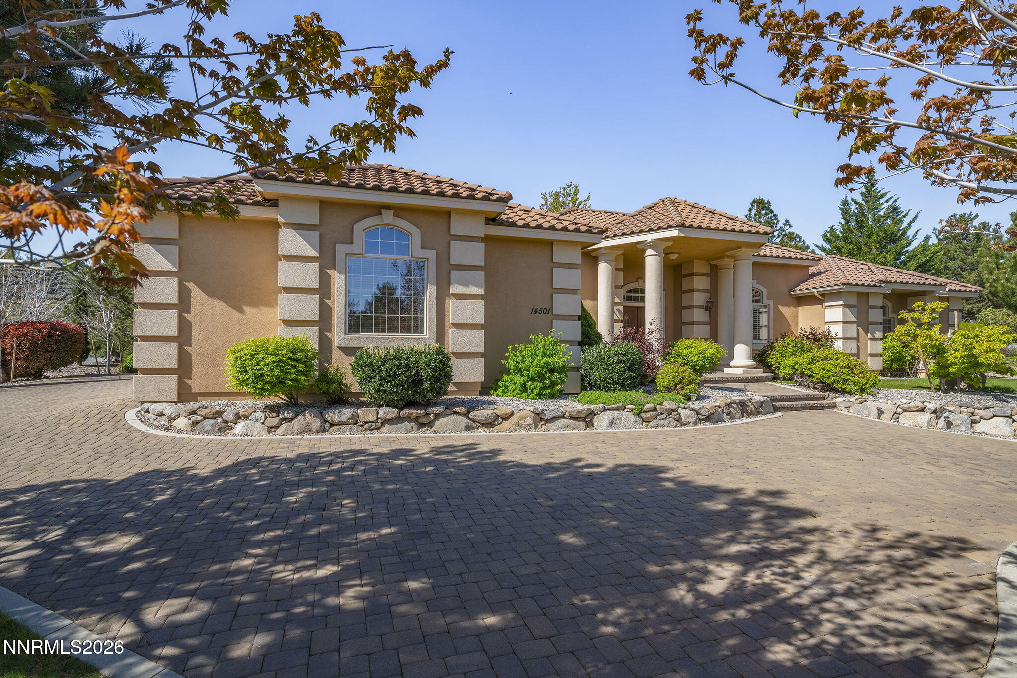 14501 Quail Rock Court Reno, NV 89511 - Photo 3 of 42 a front view of a house with a yard and a garage