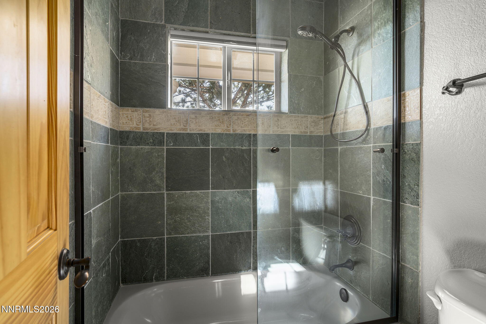 14501 Quail Rock Court Reno, NV 89511 - Photo 34 of 42 a bathroom with a glass shower door