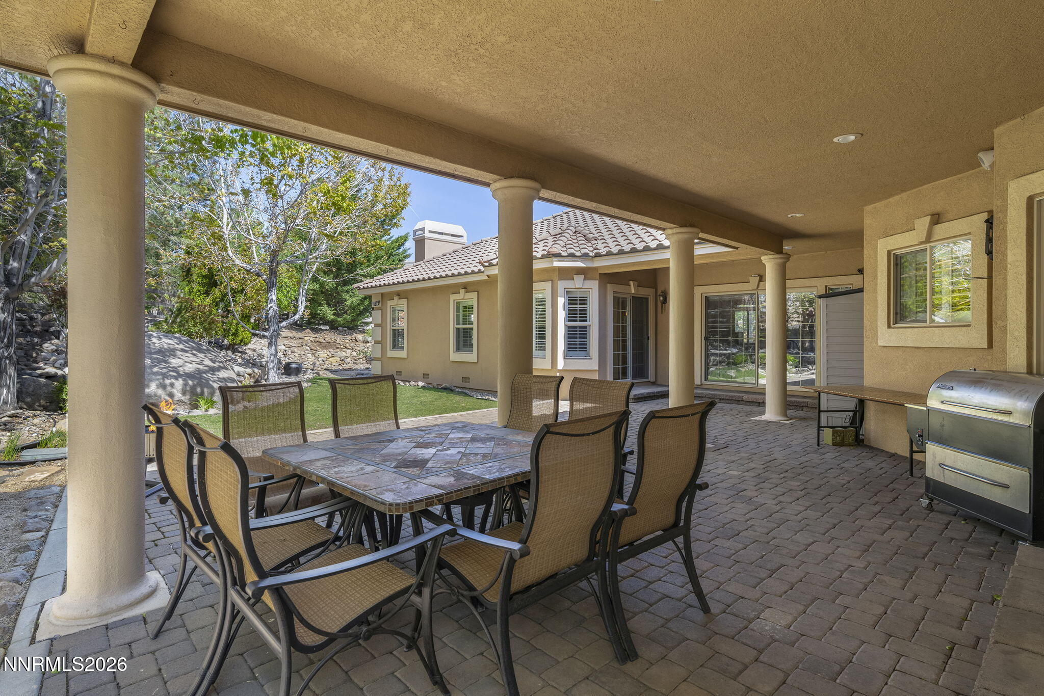 14501 Quail Rock Court Reno, NV 89511 - Photo 37 of 42 a view of a patio with a dining table and chairs